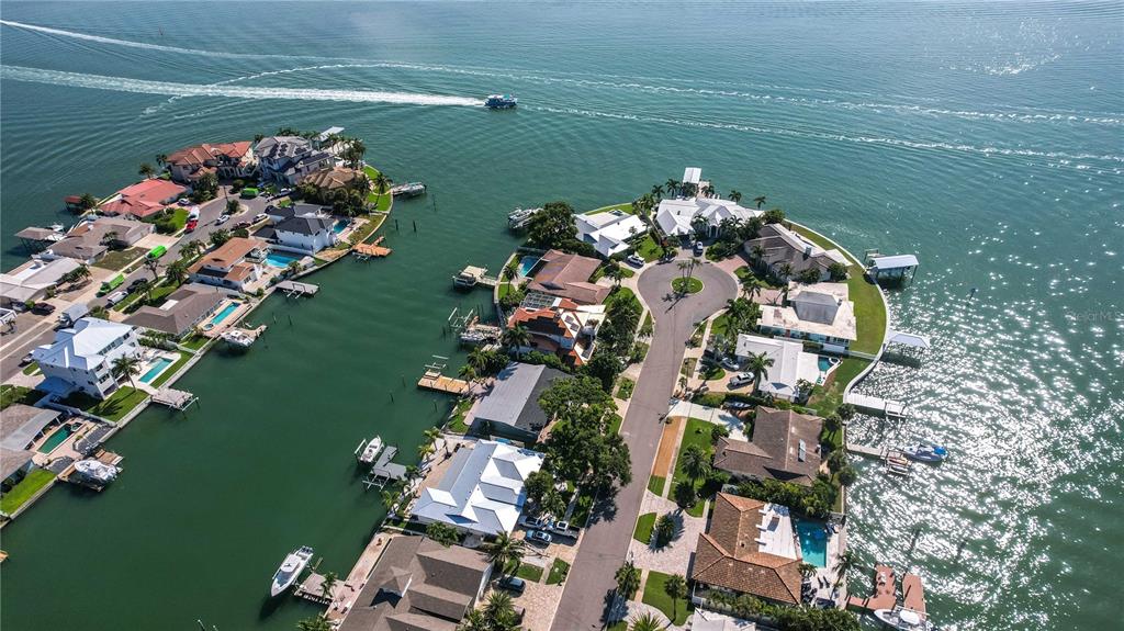 An aerial view of waterfront homes along a canal with private docks and boats — 440 PALM ISLAND SE, CLEARWATER BEACH, FL
