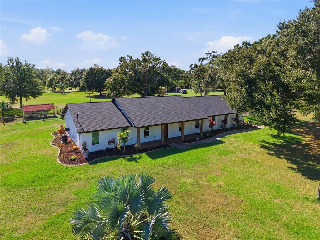An aerial view of a single-story house with a dark roof and a front porch — 2506 HAWK GRIFFIN ROAD, PLANT CITY, FL
