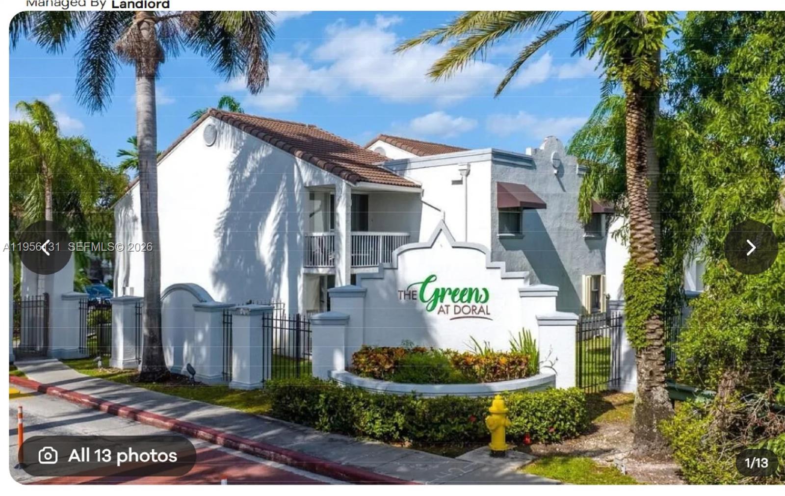The exterior of a white apartment complex entrance sign labeled The Greens at Doral — 4654 NW 97th Ct # 95, Doral FL 33178, DORAL, FL