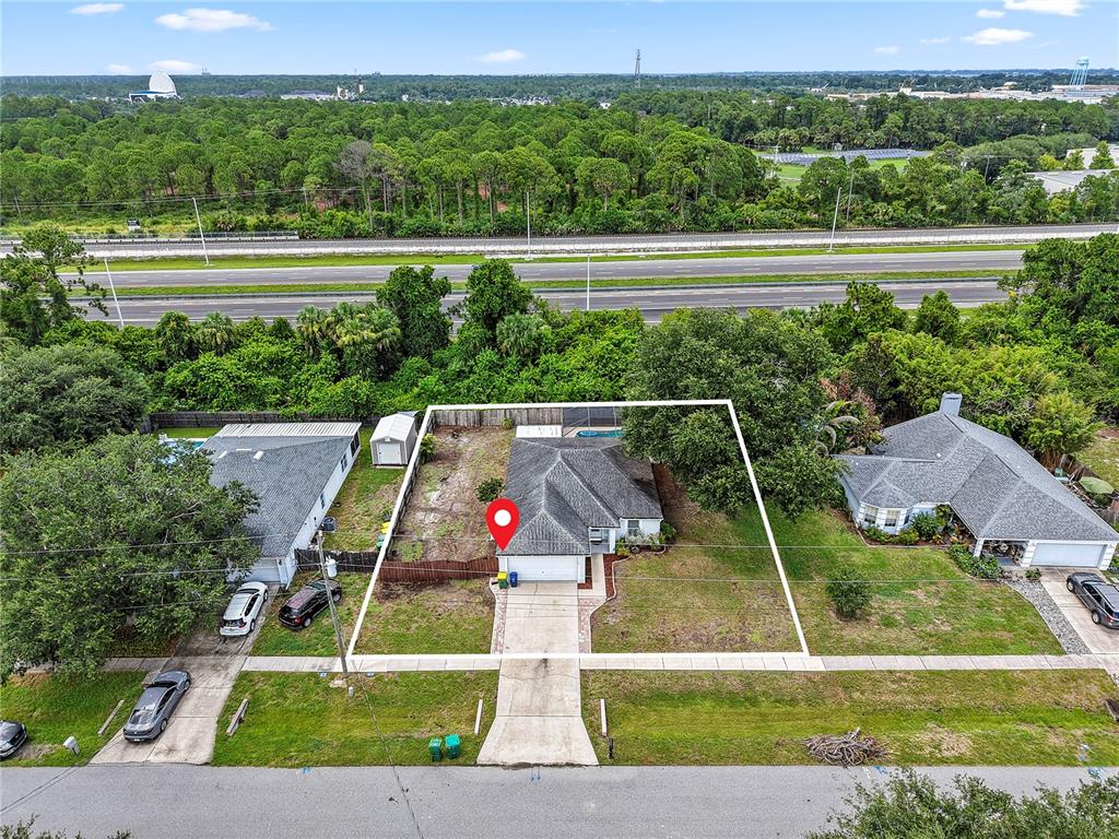 An aerial view shows a single-story house with a white outline marking its property boundaries — 3270 CRAGGY BLUFF PLACE, COCOA, FL