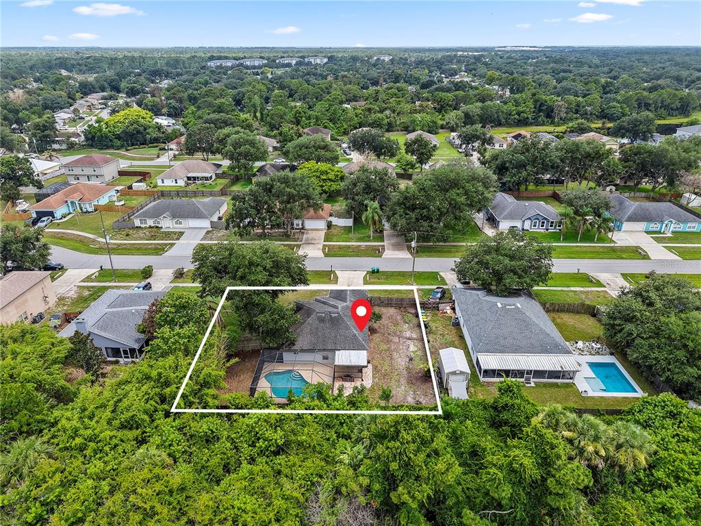 An aerial view shows a single-story house with a screened pool and a fenced backyard — 3270 CRAGGY BLUFF PLACE, COCOA, FL
