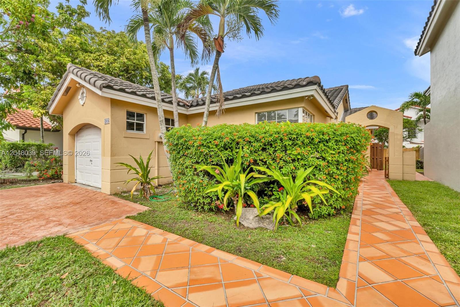 A single-story house features a tiled roof, a garage, and a landscaped front yard — 4916 SW 154th Ave, Miami FL 33185, MIAMI, FL