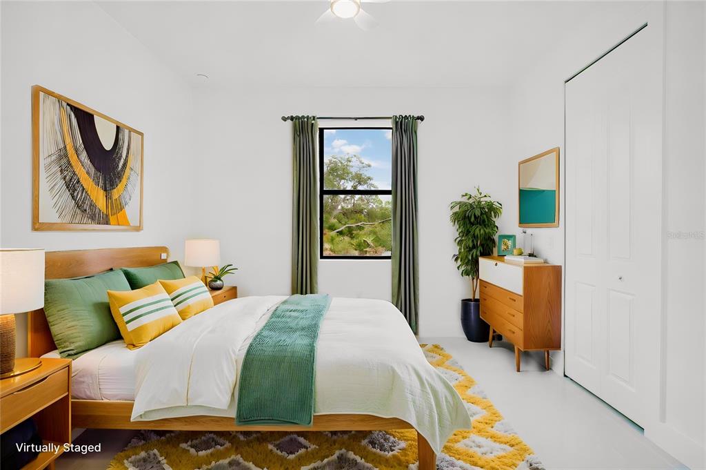 A virtually staged bedroom features a bed, a dresser, a window, and white walls — 1270 MILIKEN TERRACE, PORT CHARLOTTE, FL