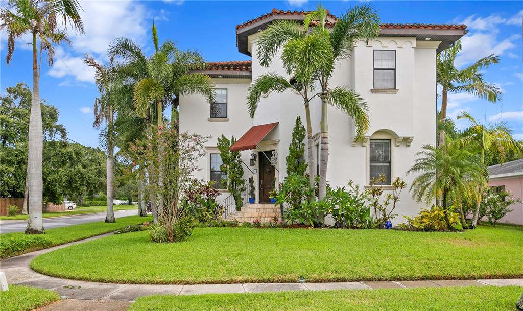 A two-story white stucco house with a red tile roof and palm trees in front — 601 BOSPHOROUS AVENUE, TAMPA, FL