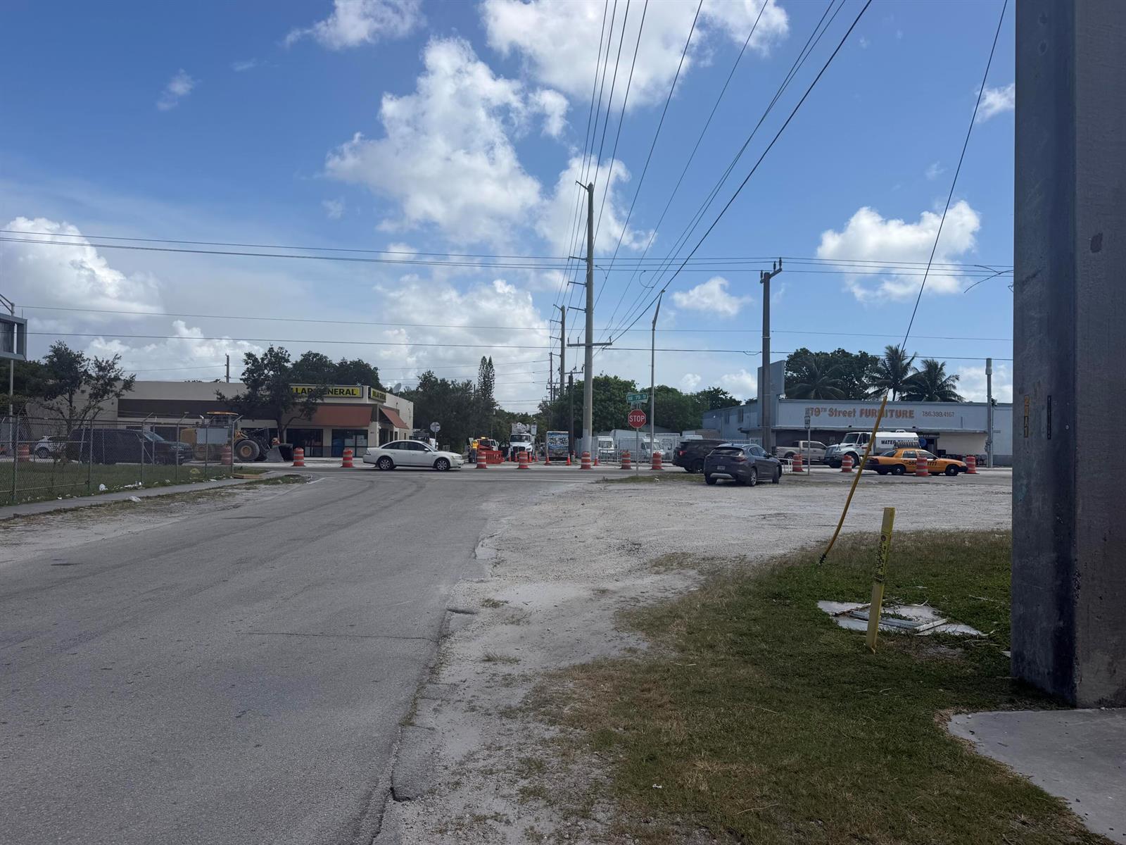 An outdoor street scene shows a road intersection with construction barrels and nearby commercial buildings — 7803 NW 8th Avenue, Miami FL 33150, MIAMI, FL
