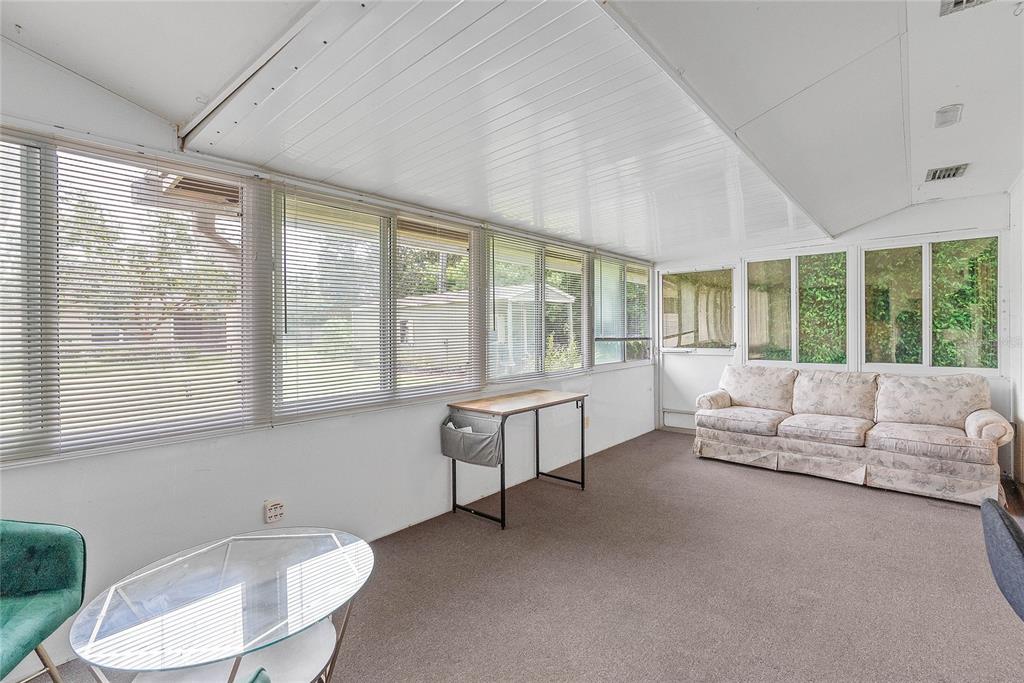 A single-story brick house with a large solar panel array on the roof and driveway — 1435 PAULA DRIVE, APOPKA, FL