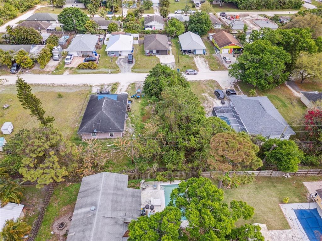 An aerial view shows several residential houses with pools and yards in a suburban neighborhood — 1335 25TH AVENUE SW, VERO BEACH, FL