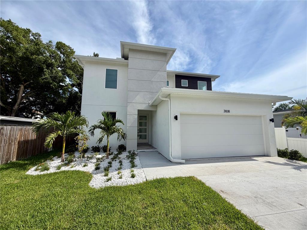 A two-story modern house with a white stucco exterior and an attached two-car garage — 3108 W BALLAST POINT BOULEVARD, TAMPA, FL