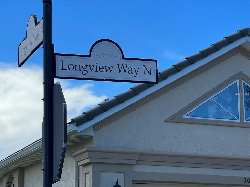 A street sign for Longview Way N stands in front of a house exterior — 108 LONGVIEW WAY N, PALM COAST, FL
