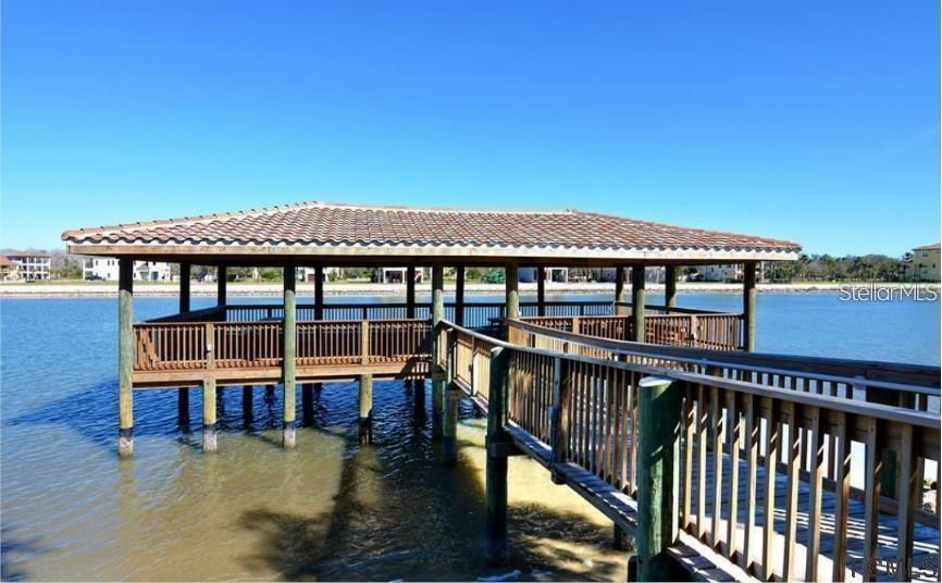 A wooden pier with a covered pavilion extends over a calm body of water — 108 LONGVIEW WAY N, PALM COAST, FL