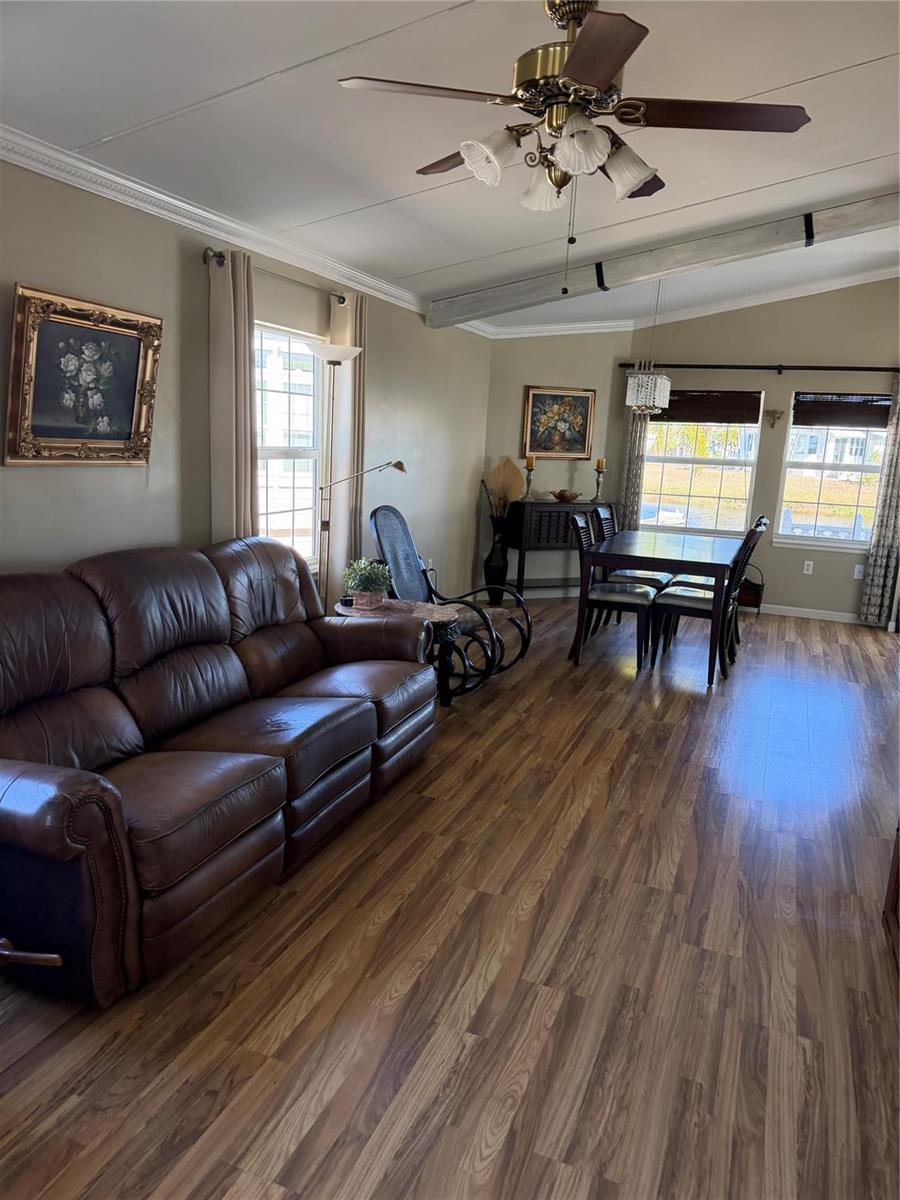 A living and dining area features wood-look flooring, a leather sofa, and a ceiling fan — 12470 SE 140th Road, Okeechobee FL 34974, OKEECHOBEE, FL