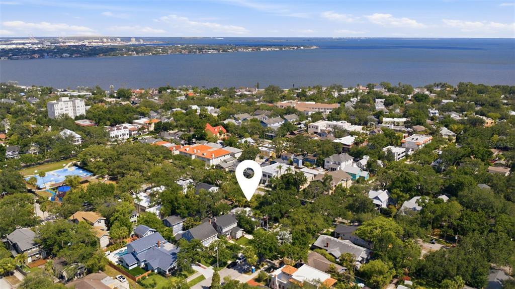 An aerial view shows a residential neighborhood with a marked property near a large bay — 912 S FREMONT AVENUE, TAMPA, FL