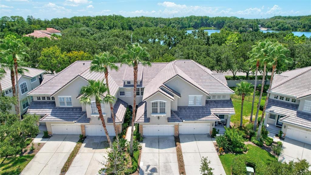 An open-concept living and dining area features tile floors, a carpeted staircase, and neutral walls — 14511 MIRABELLE VISTA CIRCLE, TAMPA, FL