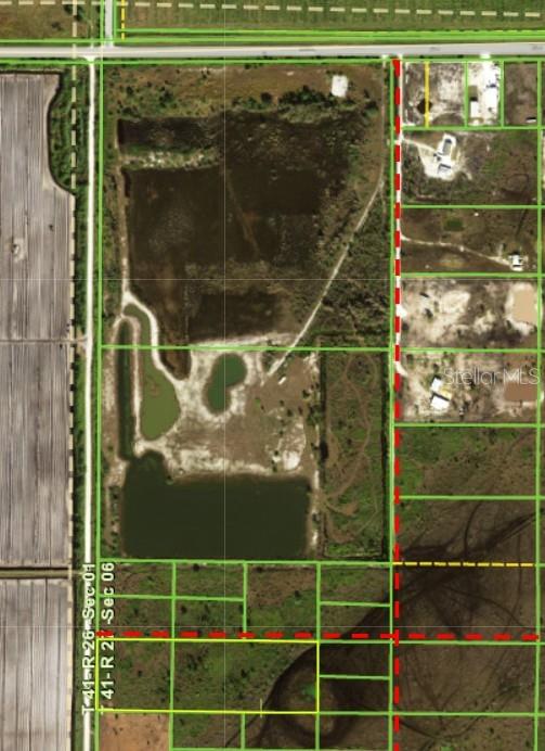 This is an aerial map showing a large parcel of land with ponds and surrounding lots — 48105 BERMONT ROAD, PUNTA GORDA, FL