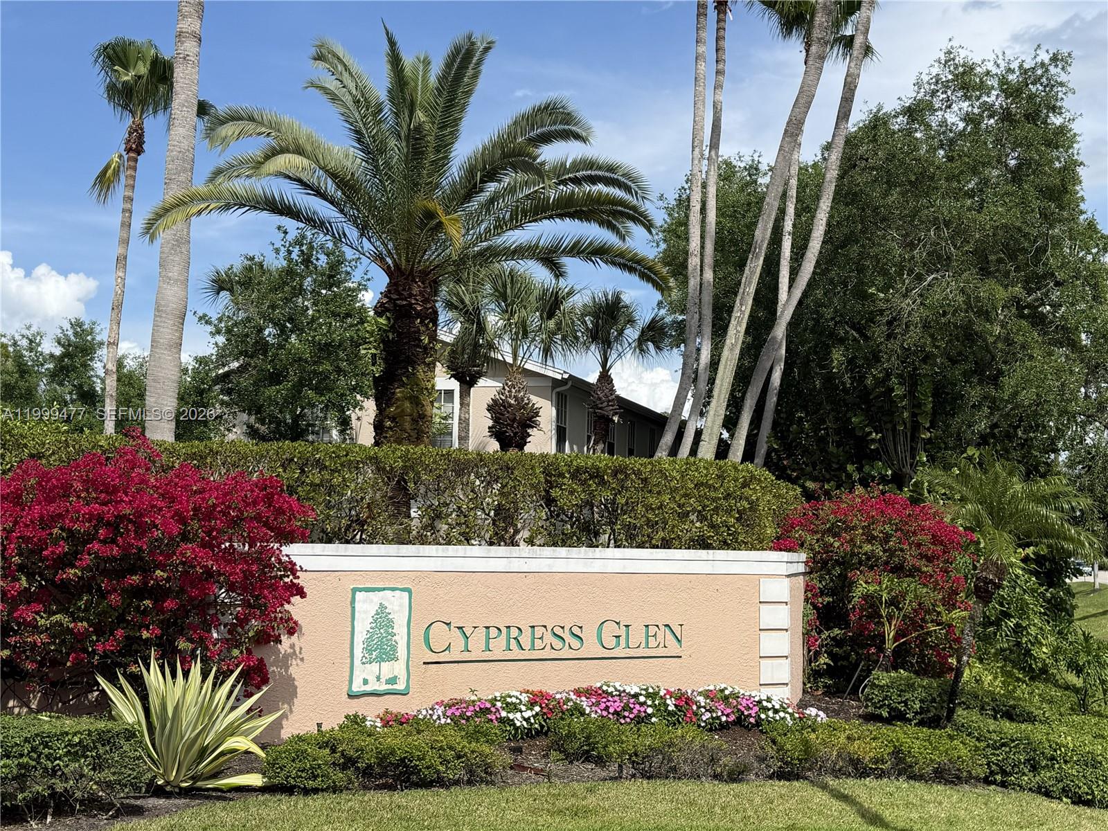 A beige stucco sign for Cypress Glen sits in front of palm trees and landscaping — 3304 Lisa Ln # 102, Naples FL 34109, NAPLES, FL
