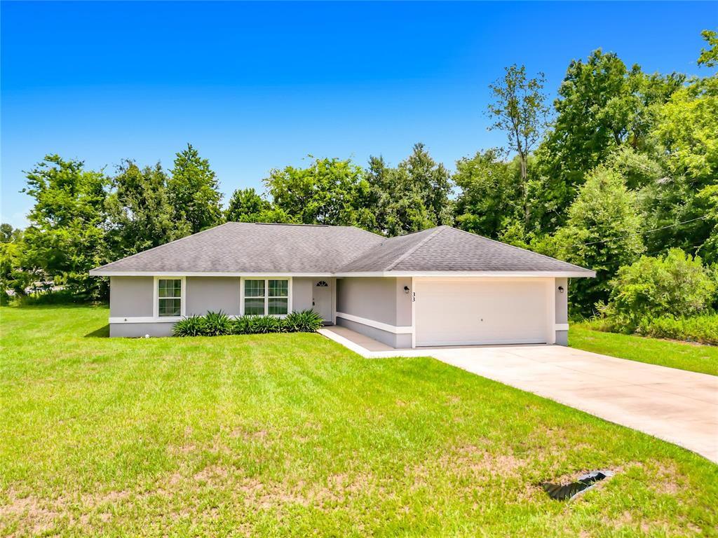 An aerial view shows a single-story house with a gray roof, driveway, and surrounding lawn — 33 JUNIPER PASS TERRACE, OCALA, FL