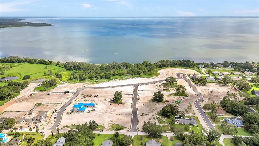 An aerial view shows a residential development under construction near a large body of water — 514 N POLLARD STREET, OAKLAND, FL