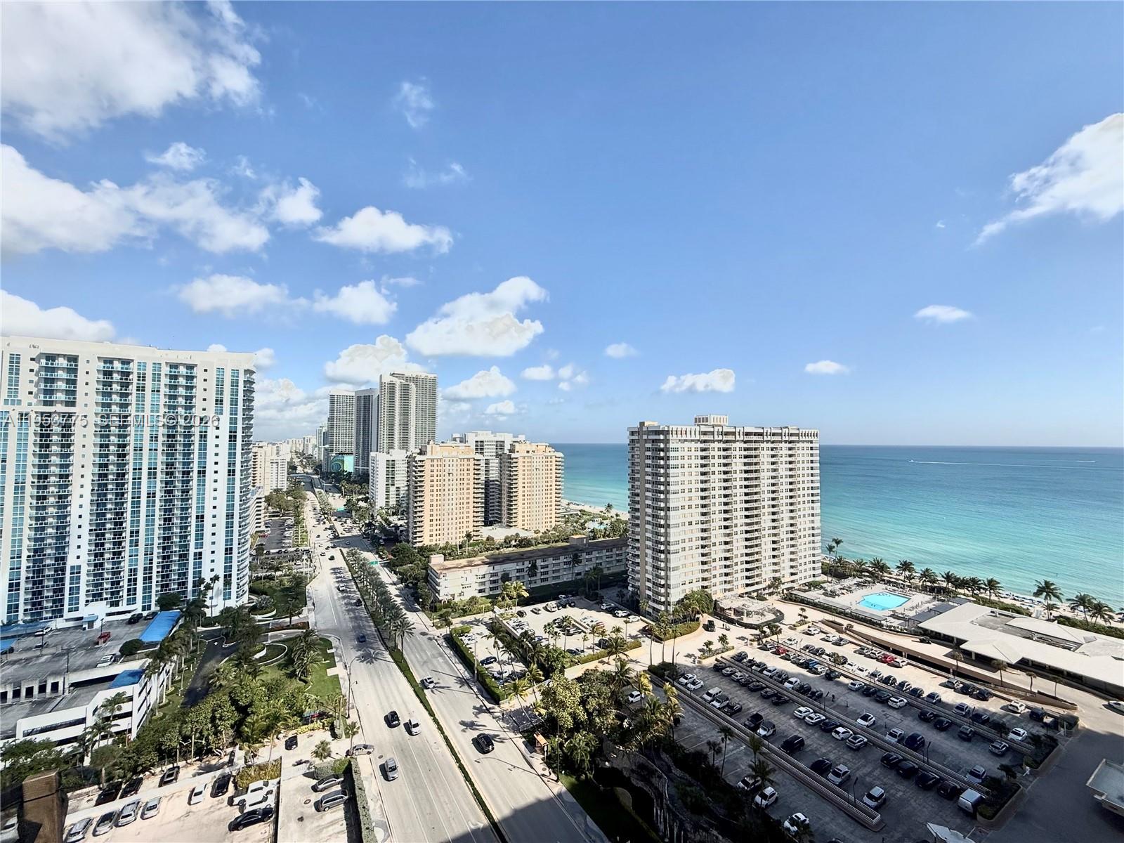 An elevated view of a coastal city street lined with high-rise buildings and parking lots — 1985 S Ocean Dr # 22P, Hallandale Beach FL 33009, HALLANDALE BEACH, FL