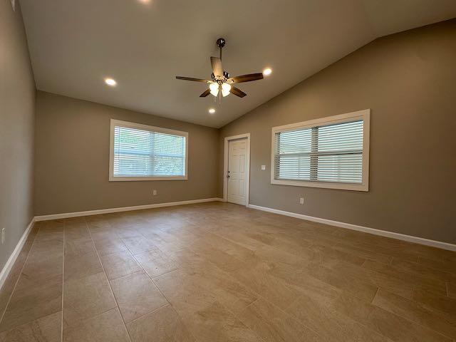 An empty room features beige tile flooring, a ceiling fan, and two windows with blinds — 3166 SE Garden Street # 3166, Stuart FL 34997, STUART, FL