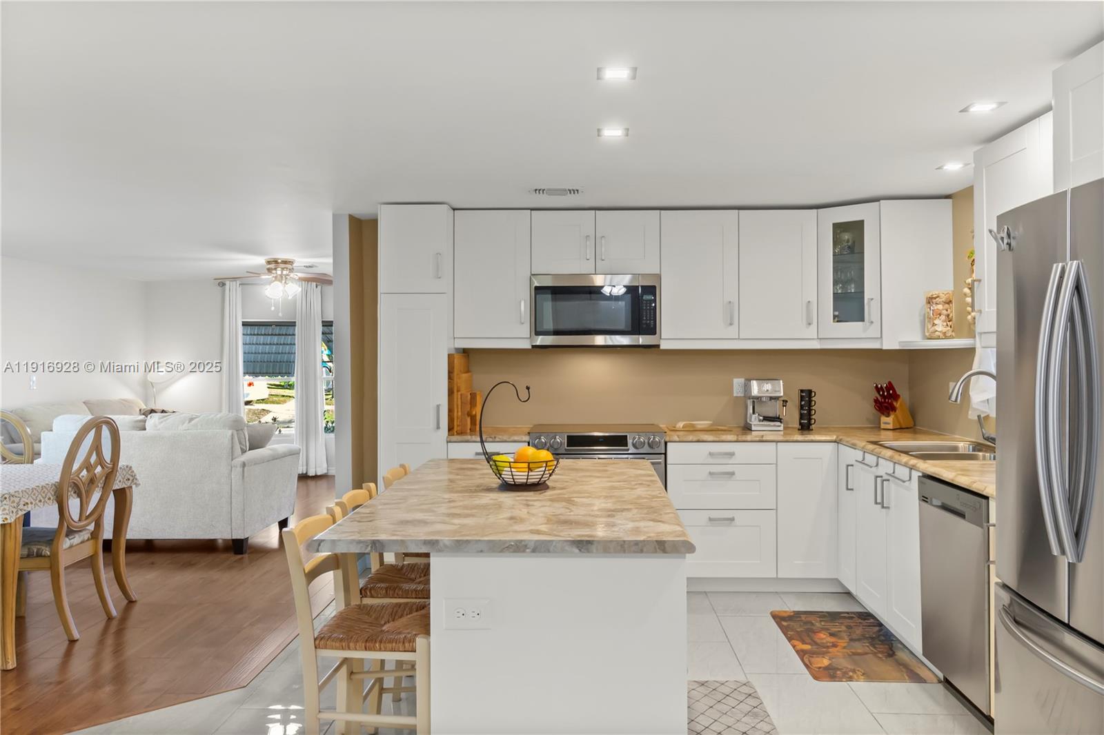 A kitchen with white cabinets, stainless steel appliances, and a marble-topped island — 5239 NW 3rd Ave, Deerfield Beach FL 33064, DEERFIELD BEACH, FL