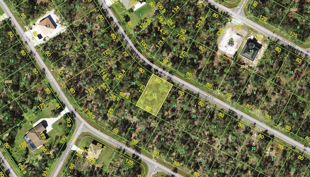 This is a satellite map showing a vacant residential lot highlighted in yellow — 1205 MADEIRA STREET, PORT CHARLOTTE, FL