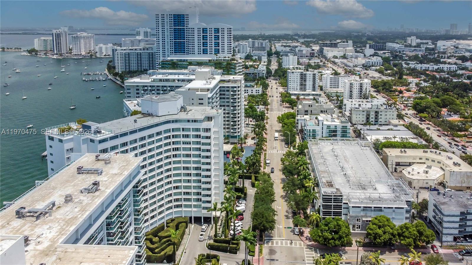 An aerial view shows a coastal city street lined with high-rise buildings and palm trees — 1100 West Ave # 322, Miami Beach FL 33139, MIAMI BEACH, FL