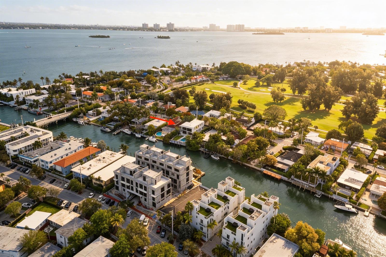 An aerial view shows waterfront homes, a canal, and a golf course near the bay — 930 S Shore Drive, Miami Beach FL 33141, MIAMI BEACH, FL