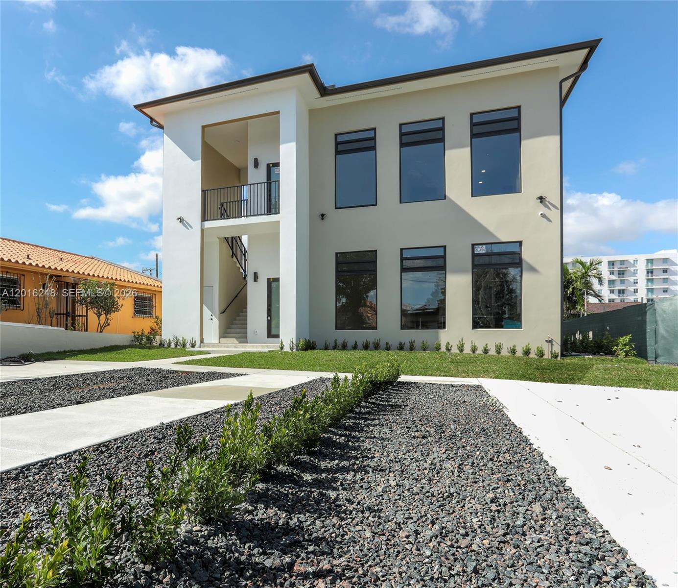 A modern two-story house with a white recessed entryway, balcony, and large rectangular windows — 120 SW 35 Ave # A2, Miami FL 33135, MIAMI, FL