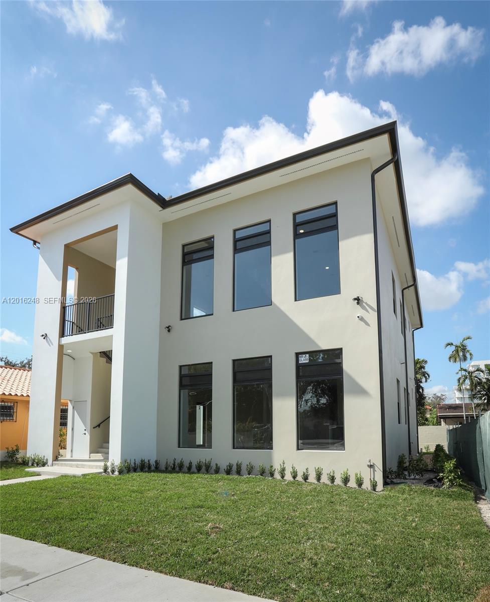A two-story modern house with a white stucco exterior and large black-framed windows — 120 SW 35 Ave # A2, Miami FL 33135, MIAMI, FL