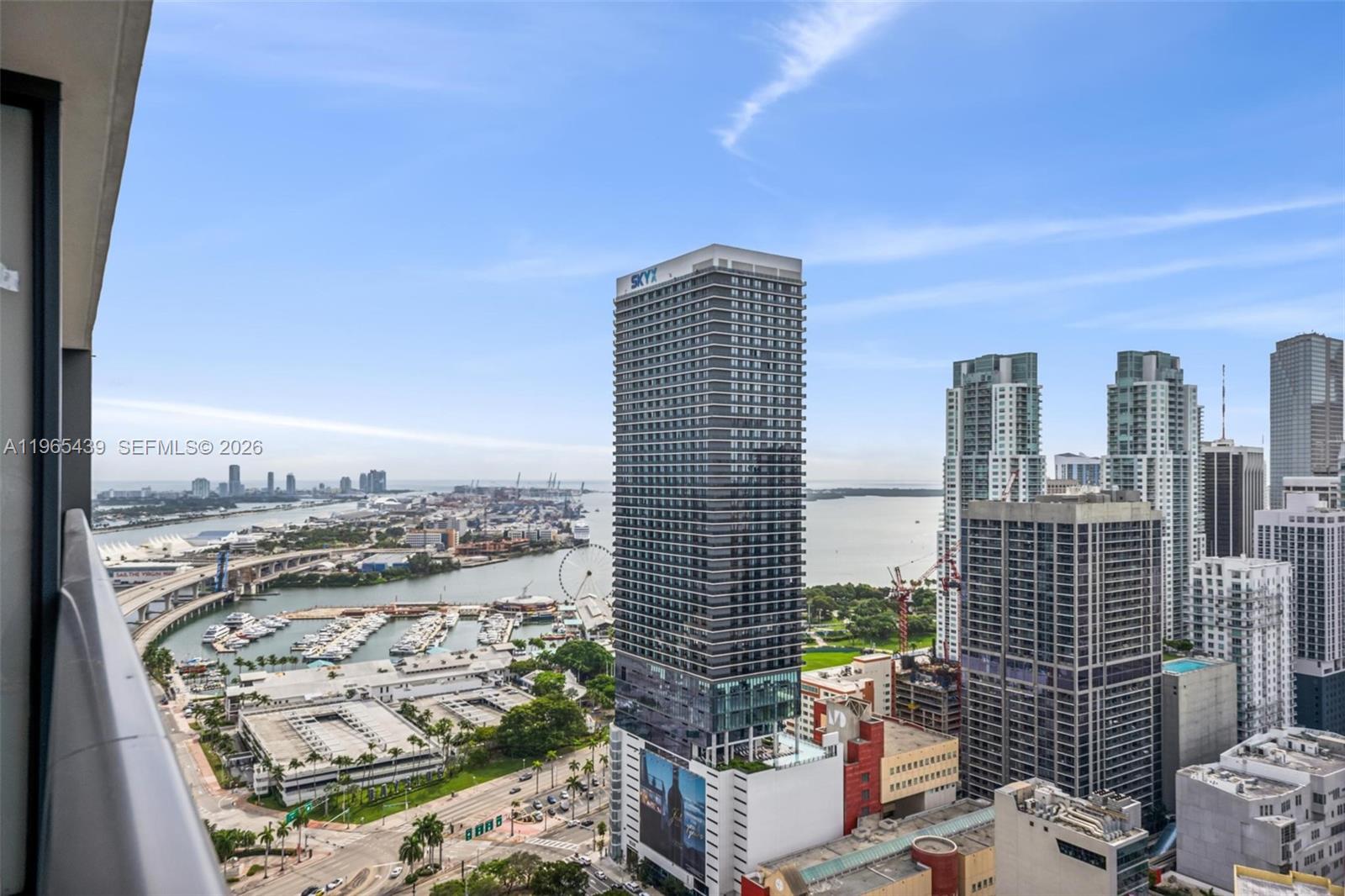 An elevated view shows a tall skyscraper in a city with a marina and bay — 159 NE 6th St # 3312, Miami FL 33132, MIAMI, FL