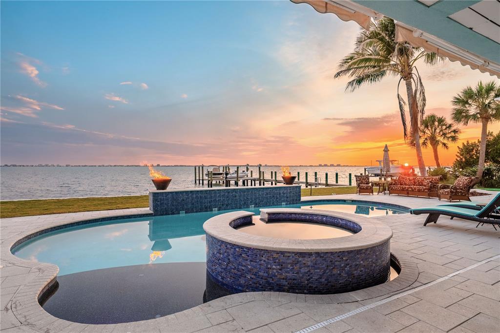 An aerial view of a blue waterfront house with a paved driveway and palm trees — 350 S SHORE DRIVE, SARASOTA, FL