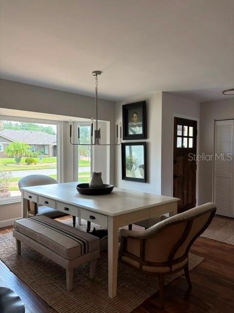 A dining room features a white table, a bench, an armchair, and a chandelier — 1431 ROOSEVELT DRIVE, VENICE, FL