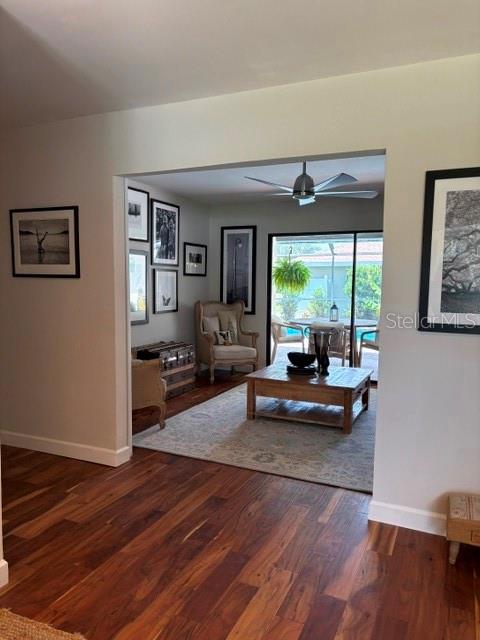 A living room features hardwood floors, a wooden coffee table, and a sliding glass door — 1431 ROOSEVELT DRIVE, VENICE, FL