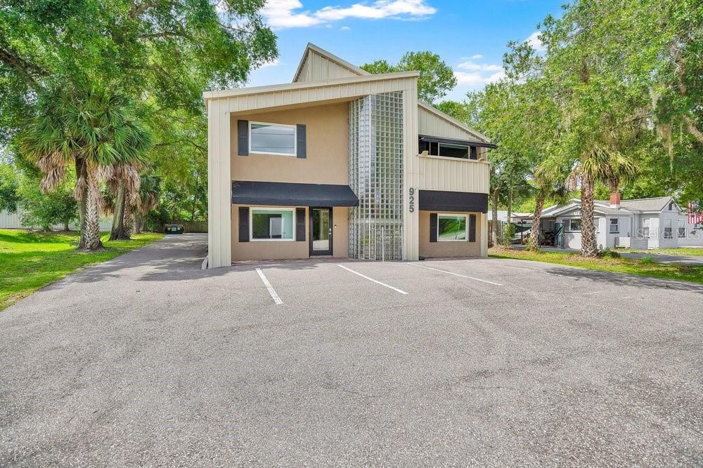A two-story commercial building with a glass block column and an asphalt parking lot — 925 W SR 434, WINTER SPRINGS, FL