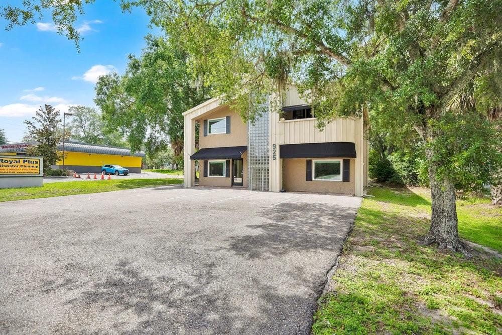 A two-story commercial building with a tan exterior, black awnings, and a glass block accent — 925 W SR 434, WINTER SPRINGS, FL