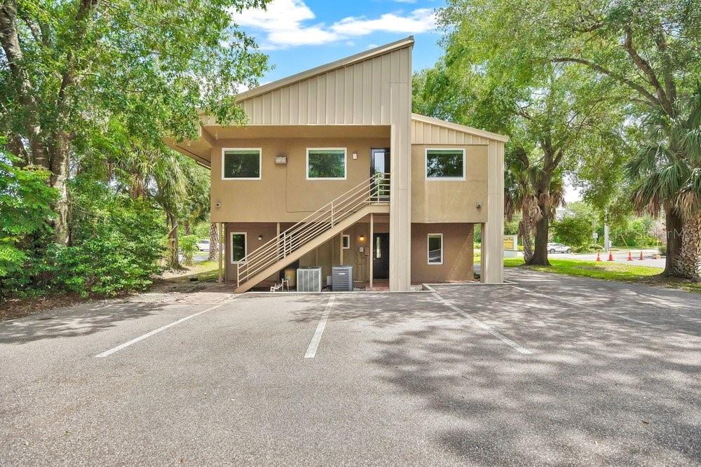 A two-story commercial building with an exterior metal staircase and a paved parking lot — 925 W SR 434, WINTER SPRINGS, FL