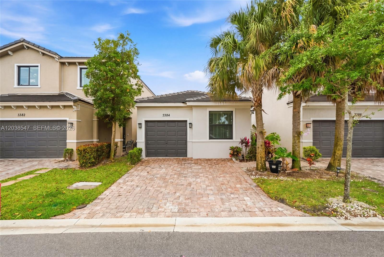 A single-story residential building with a paved driveway and palm trees in the front yard — 3384 NW 5th St, Pompano Beach FL 33069, POMPANO BEACH, FL