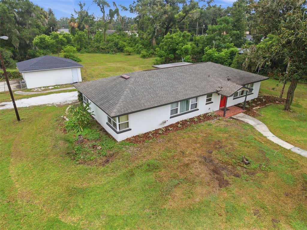 An aerial view shows a white single-story house with a gray roof and a detached garage — 625 LIMONA ROAD, BRANDON, FL