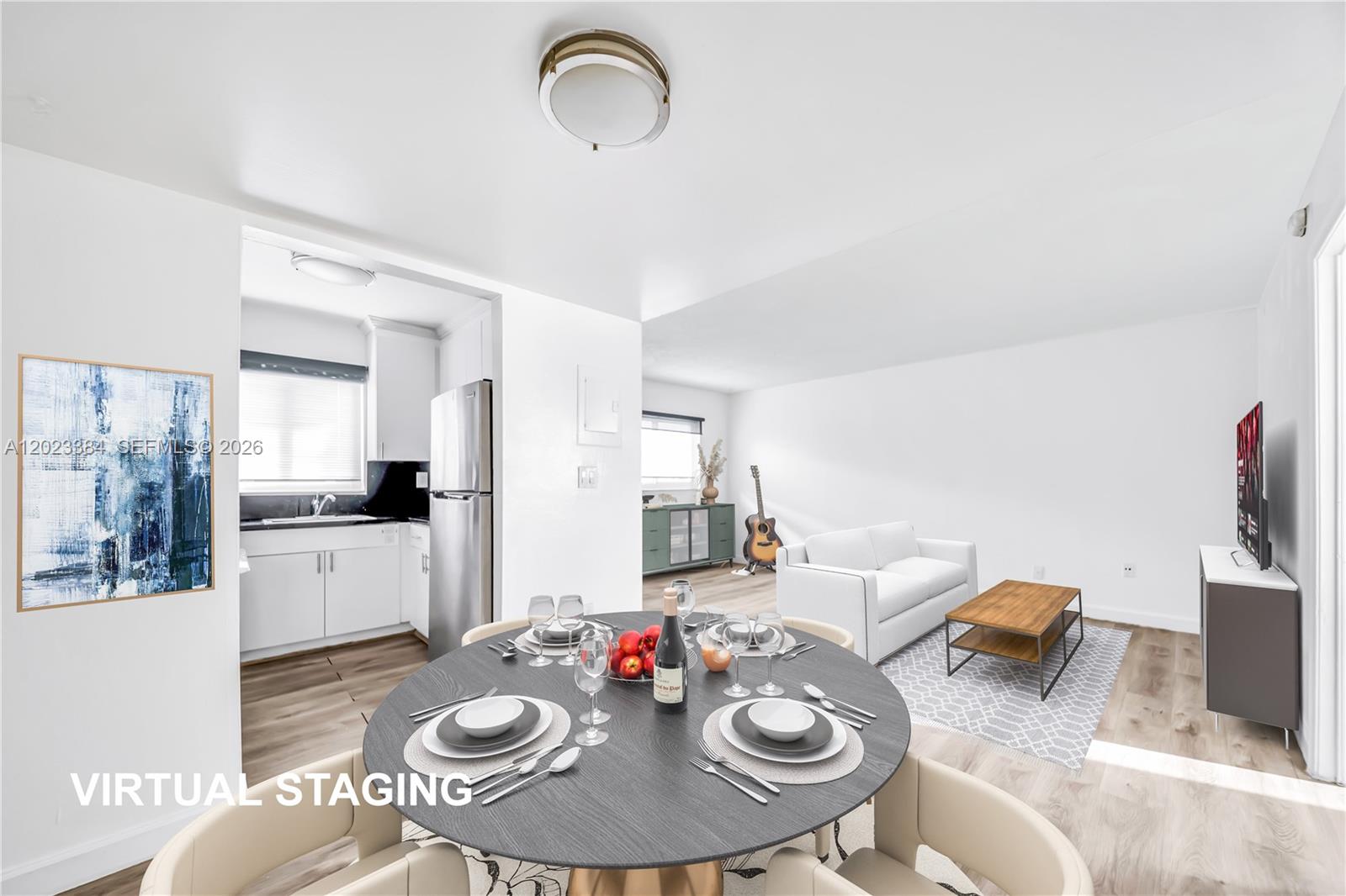This virtual staging shows a dining area and living room with light wood-look flooring — 2011 Bay Dr # 8, Miami Beach FL 33141, MIAMI BEACH, FL