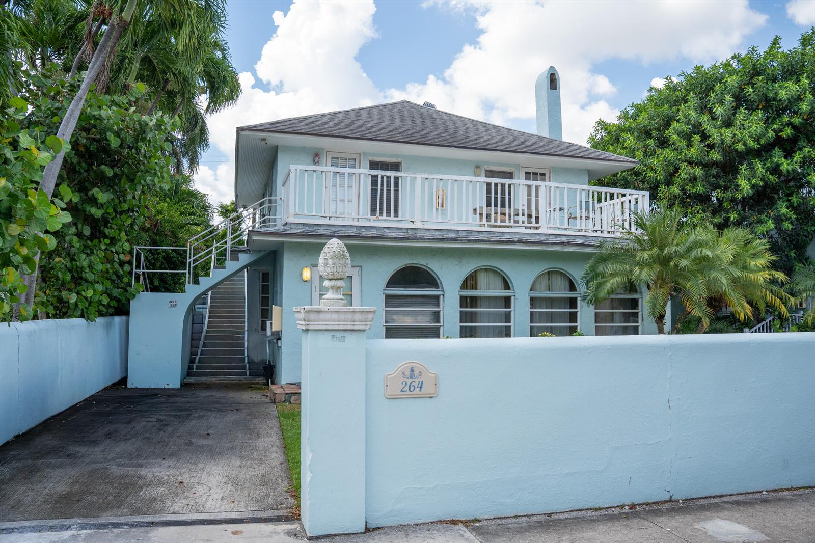 A light blue two-story house features an exterior staircase, a second-floor balcony, and arched windows — 264 Seminole Avenue, Palm Beach FL 33480, PALM BEACH, FL