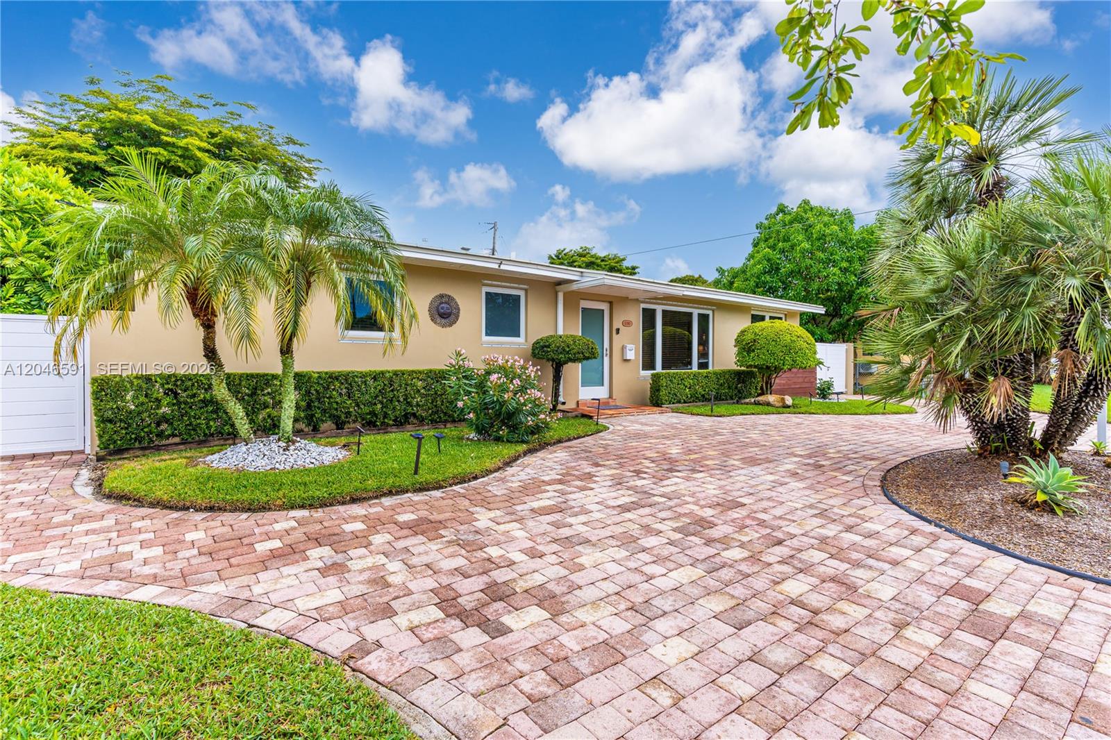 A single-story house with a paved driveway, palm trees, and manicured landscaping — 11180 SW 58th Ter, Miami FL 33173, MIAMI, FL