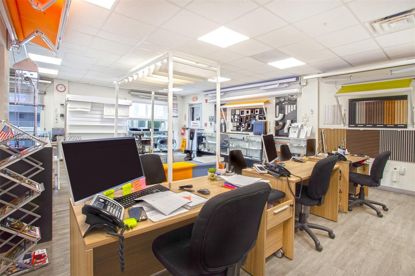 A bright office space features multiple desks, computer workstations, and various product displays on walls — 2290 W 8th Ave, Hialeah FL 33010, HIALEAH, FL