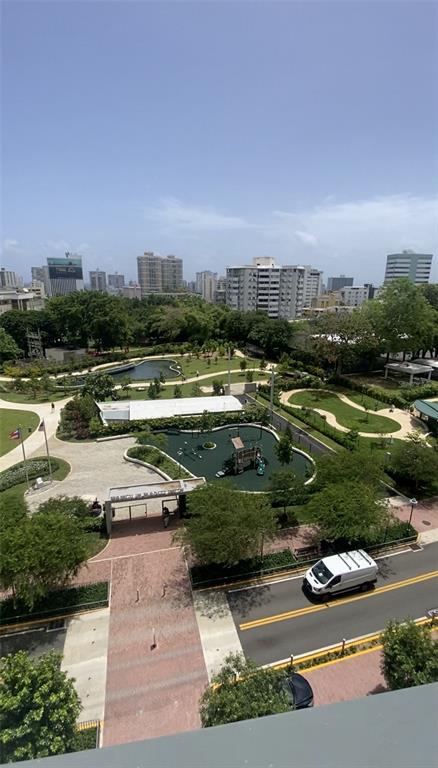 An elevated view of a park with a playground, walking paths, and surrounding city buildings — 1511 PONCE DE LEON AVENIDA UNIT 1052, SAN JUAN, PR