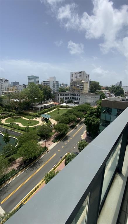 An elevated view shows a city street, a park with trees, and surrounding urban buildings — 1511 PONCE DE LEON AVENIDA UNIT 1052, SAN JUAN, PR
