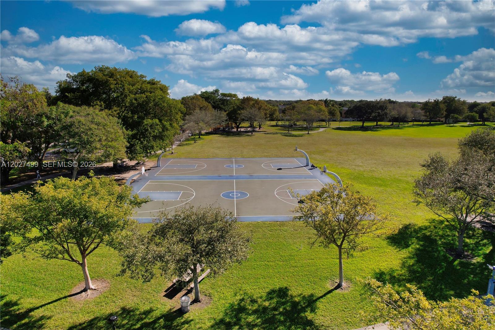 An aerial view shows an outdoor basketball court situated in a grassy park with trees — 3305 SW 114 CT # 2, Miami FL 33165, MIAMI, FL