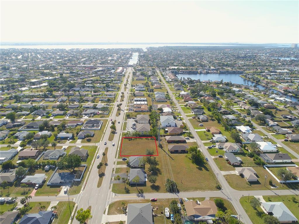 An aerial view shows a vacant rectangular lot outlined in red within a residential neighborhood — 4412 SANTA BARBARA BOULEVARD, CAPE CORAL, FL