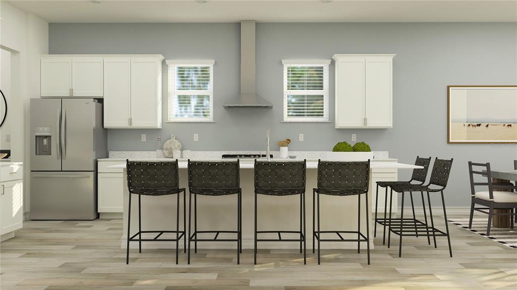 This is a digital rendering of a modern kitchen featuring white cabinetry, stainless appliances, and island seating — 11580 69T PLACE E, PALMETTO, FL