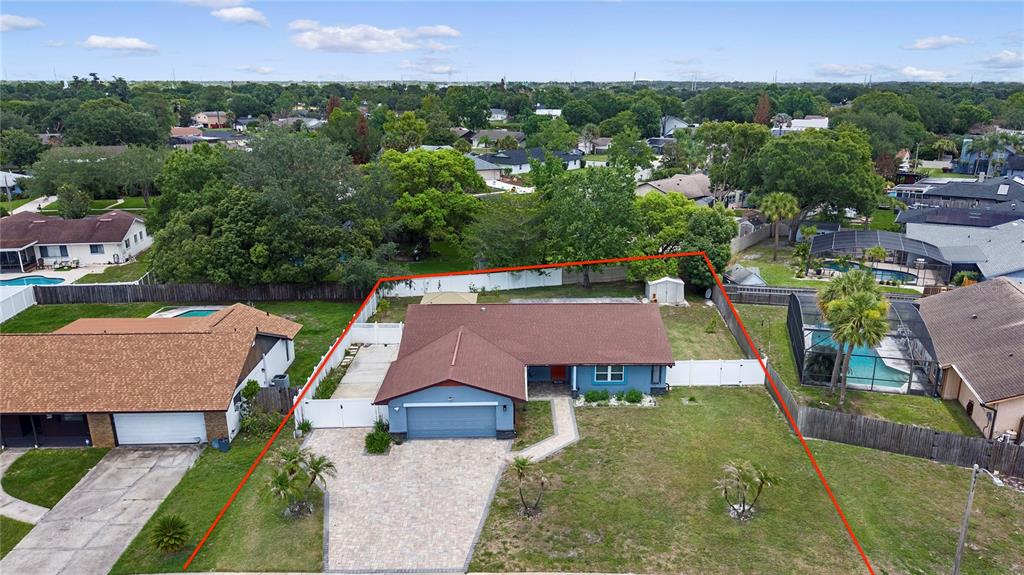 An aerial view shows a residential neighborhood with a house highlighted near a golf course — 1055 PALOS VERDE DRIVE, ORLANDO, FL