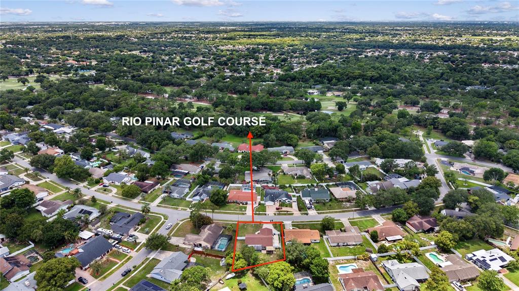 An aerial view of a golf course green surrounded by trees at sunset — 1055 PALOS VERDE DRIVE, ORLANDO, FL