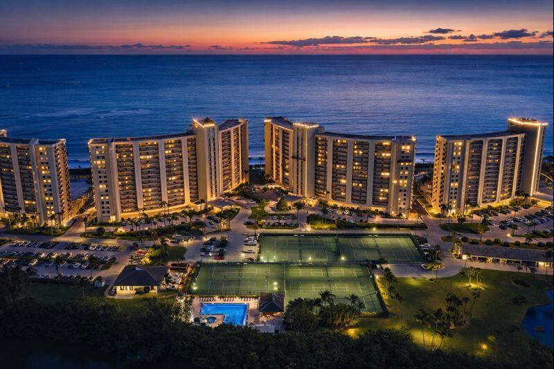 An aerial view of three large residential buildings by the ocean at sunset — 500 Ocean Trail Way # 305, Jupiter FL 33477, JUPITER, FL